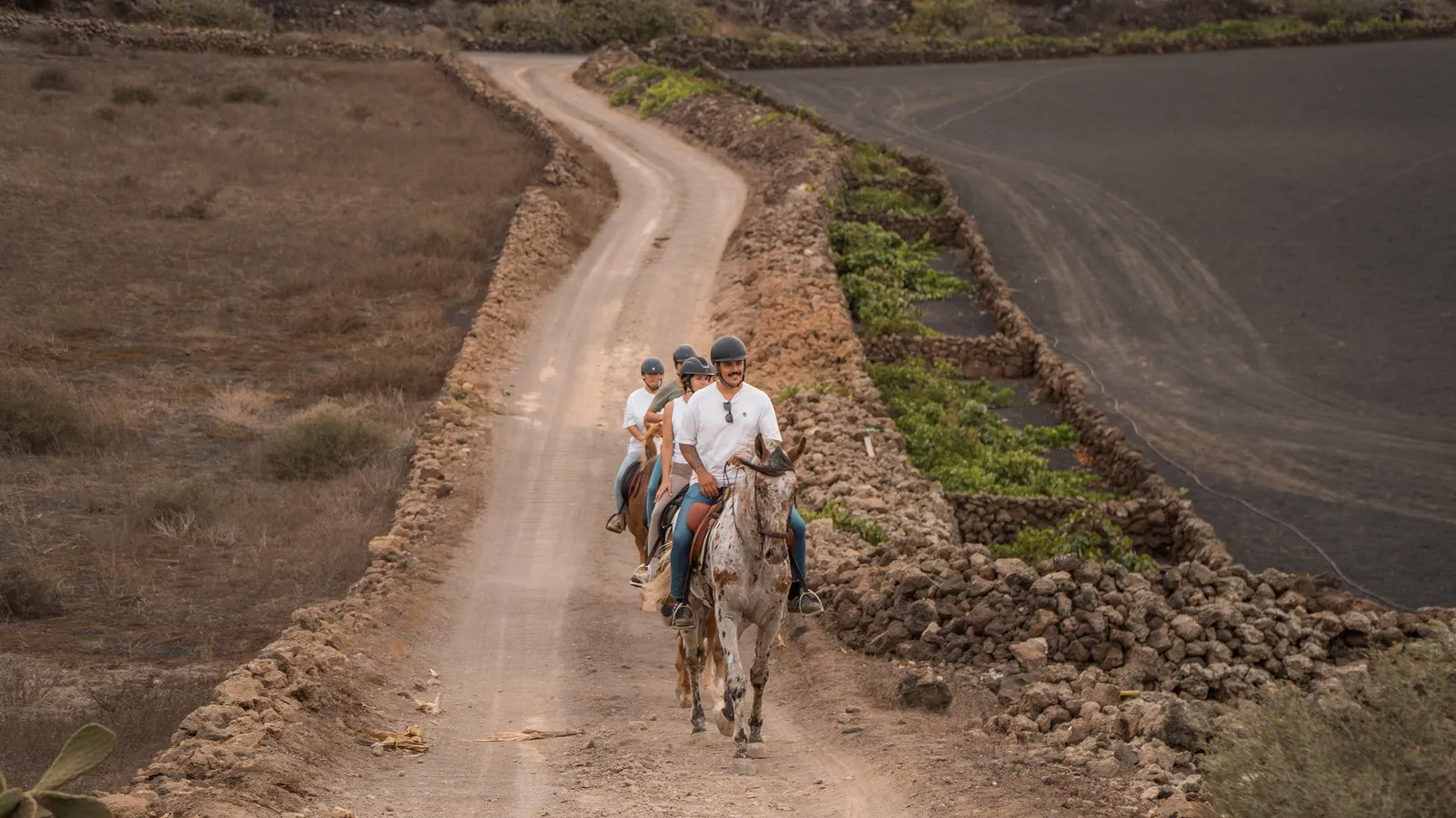 Riders coming down a track between volcanoes
